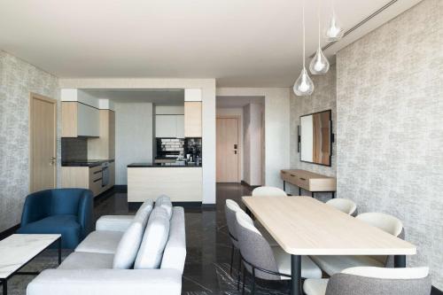 a kitchen and dining room with a table and chairs at Park Inn by Radisson Hotel & Apartments Kuwait in Kuwait