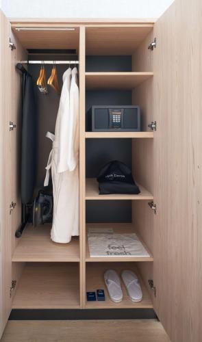 a closet with wooden shelves and a microwave in it at Park Inn by Radisson Hotel & Apartments Kuwait in Kuwait