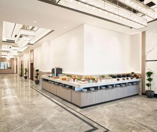 a cafeteria with a buffet line in a building at Park Inn by Radisson Hotel & Apartments Kuwait in Kuwait
