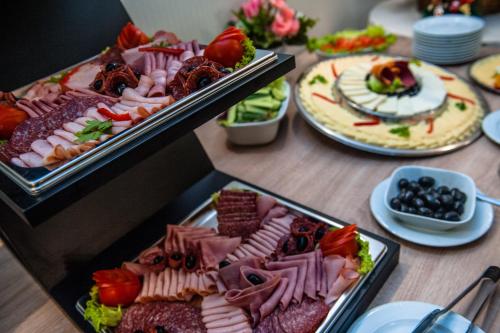 a table with a bunch of different types of food at Hotel Parc Sibiu in Sibiu