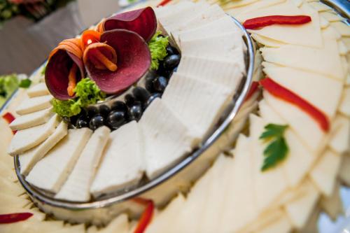 a close up of a cake with vegetables on it at Hotel Parc Sibiu in Sibiu