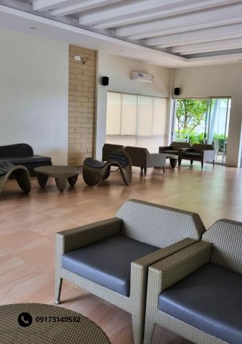 a living room with couches and tables in a room at Marina Oasis Two Bed Room Condo Unit in Dumaguete