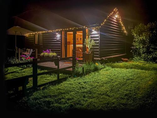 a house lit up at night with lights at The Little Barn in Hoxne