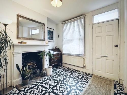 a room with a fireplace and a white door at St Clements Guesthouse in Oxford