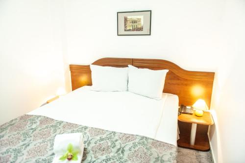 a hotel room with a bed with a flower on it at Hotel Parc Sibiu in Sibiu
