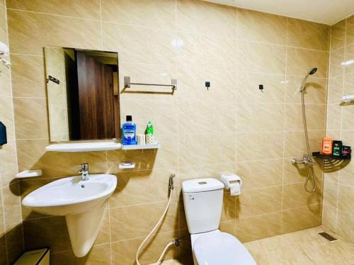 a bathroom with a toilet and a sink at Apartment in Cam Pha city with amazing ocean view in Quang Ninh