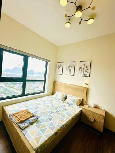 a bedroom with a bed and a large window at Apartment in Cam Pha city with amazing ocean view in Quang Ninh