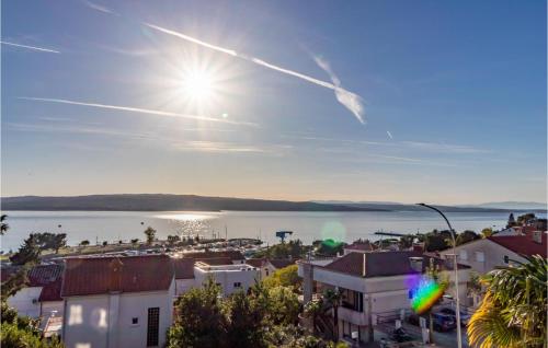 a view of a city with the sun in the sky at Awesome Apartment In Crikvenica in Crikvenica