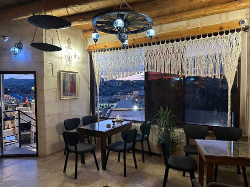 a dining room with a table and chairs and a window at Mizan Cave Cappadocia in Nevsehir