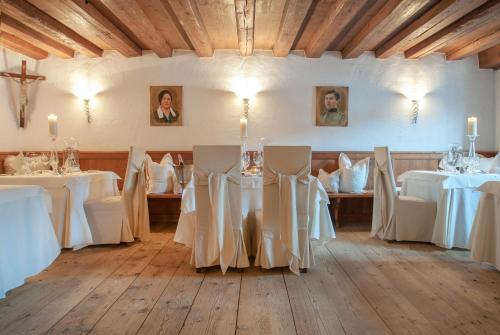a room with tables and chairs with white table cloth at Hotel Alpenblick Zillertal in Hippach