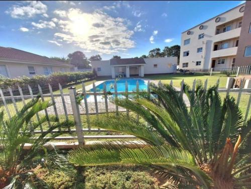 a view of a swimming pool at a apartment complex at Hartenlief apartment in Mossel Bay