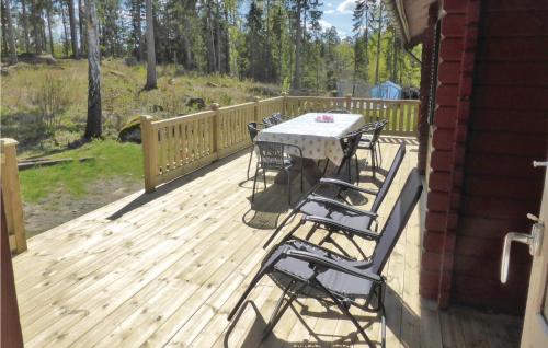 a patio with a table and chairs on a deck at Gorgeous Home In Flen With Sauna in Flen