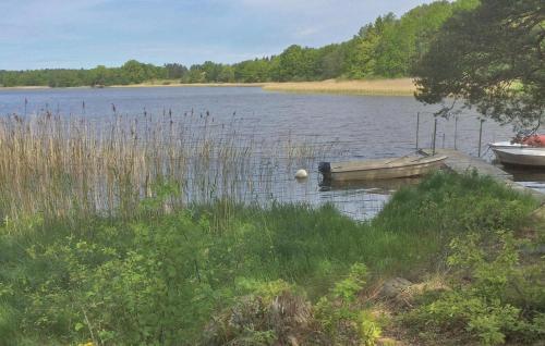 two boats are docked at a dock on a lake at Gorgeous Home In Flen With Sauna in Flen