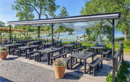 a group of tables and benches under a pavilion at Stunning Home In Gnesta With Wifi in Gnesta
