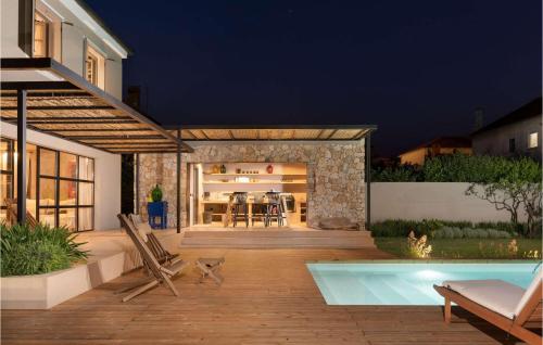 a backyard with a swimming pool and a house at Villa Em in Zadar