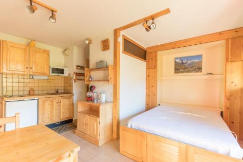 une cuisine avec un lit dans une chambre dans l'établissement Génépi - Studio pour 5 vue montagne, à Vars