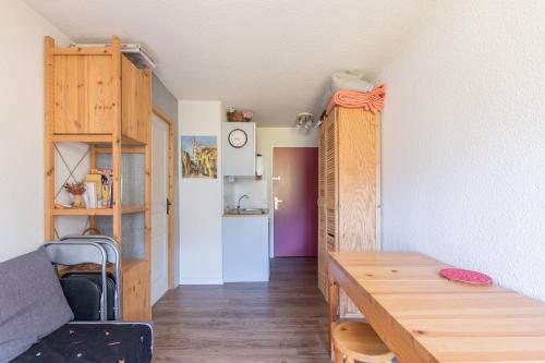 une chambre avec une table et une chambre avec un canapé dans l'établissement Faliju - appartement avec vue montagne, à Vars