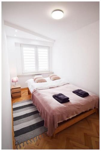a bedroom with a large bed and a window at Color 24 Apartament VIII in Stalowa Wola