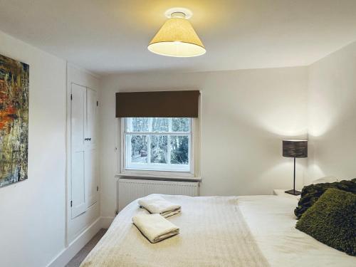 a bedroom with a bed with two towels on it at St Clements Guesthouse in Oxford