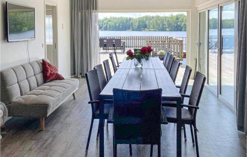 a dining room with a long table and chairs at Stunning Home In Tingsryd With Wifi in Tingsryd