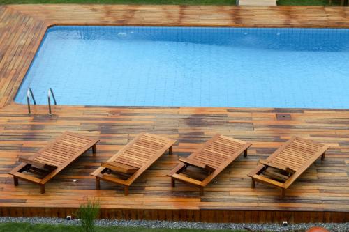 two lounge chairs and a swimming pool in front at Le Patio in Lomé