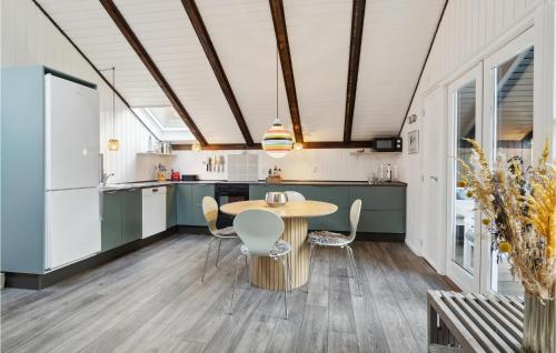a kitchen with a wooden table and chairs at Awesome Home In Oksbøl With Wifi in Oksbøl