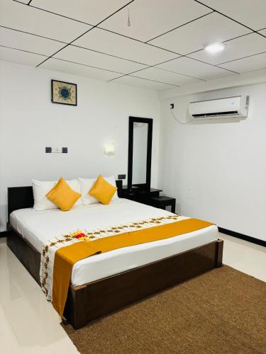 a bedroom with a large bed in a room at Forest Dew Udawalawa in Udawalawe