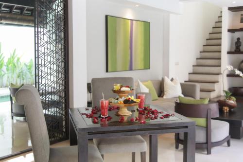 a dining room table with a bowl of food on it at The Amala Boutique Retreat in Seminyak