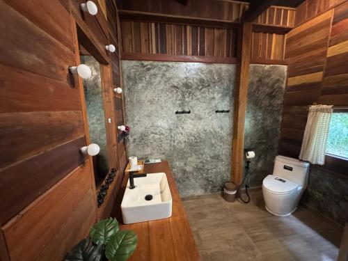 a bathroom with a sink and a toilet at Mii Paa Aii มิ๊ ป๊ะ ไอ in Chiang Mai