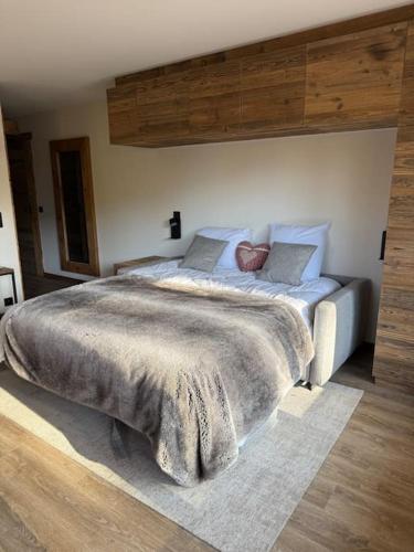 une chambre avec un grand lit dans une pièce dans l'établissement Studio Cosy cœur de Megève Le Soleil Levant, à Megève