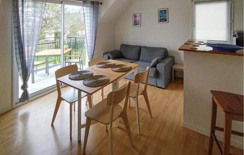 un salon avec une table, des chaises et un canapé dans l'établissement 1 Bedroom Lovely Apartment In Carantec, à Carantec