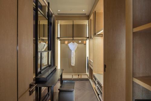 a dressing room with a shirt hanging on a rack at Hilton Shenzhen Shekou Nanhai in Shenzhen