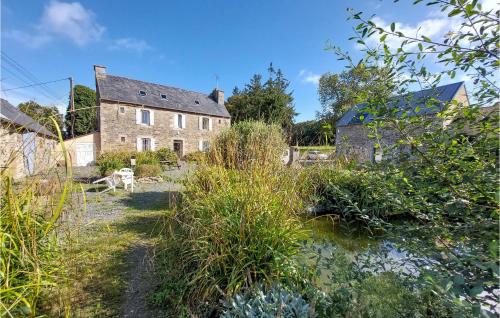 an old house in the middle of a garden at 6 Bedroom Lovely Home In Tréguier in Tréguier