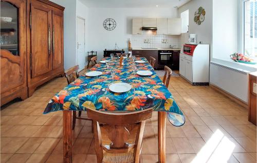 a long dining room table with a colorful table cloth at 6 Bedroom Lovely Home In Tréguier in Tréguier