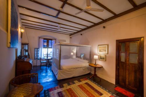 a bedroom with a canopy bed in a room at Old Courtyard Hotel in Cochin