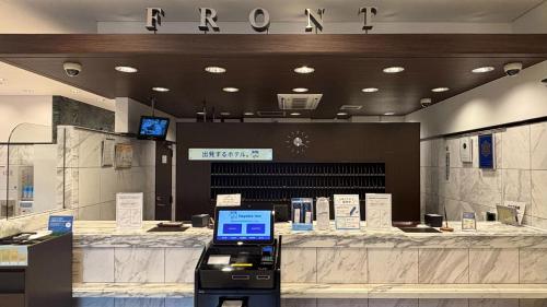 a store with a cash counter with a laptop on it at Toyoko Inn Toyohashi eki Higashi guchi in Toyohashi