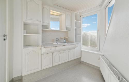 a white bathroom with a sink and a window at Gorgeous Home In Otterup With Kitchen in Otterup
