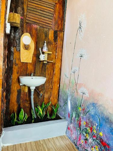 a bathroom with a sink on the wall at Chậm Homestay Đà Lạt in Da Lat