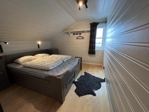 a small bedroom with a bed in the attic at Large balcony with panoramic mountain views in Beitostøl