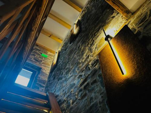 a clock on the side of a stone wall at Spa Villa Mezinska Jacuzzi Sauna in Shiroka Lŭka