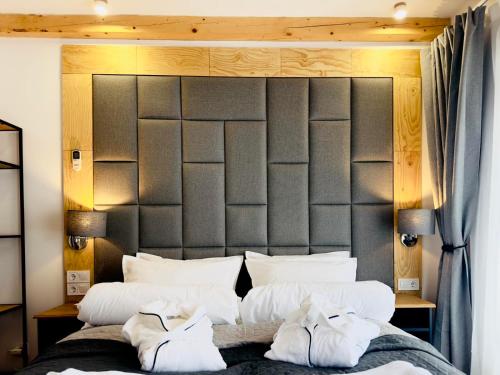 a bedroom with a large bed with two towels on it at Spa Villa Mezinska Jacuzzi Sauna in Shiroka Lŭka