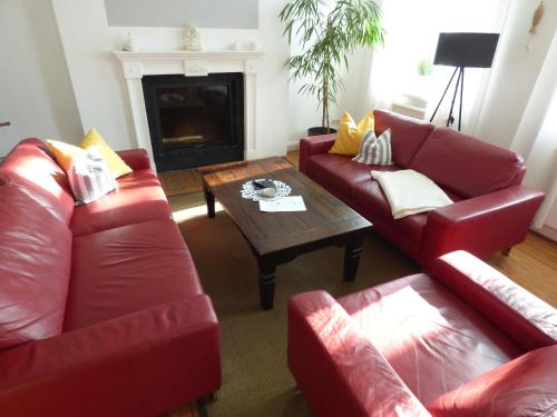 a living room with two red couches and a coffee table at Morizan in Röbel