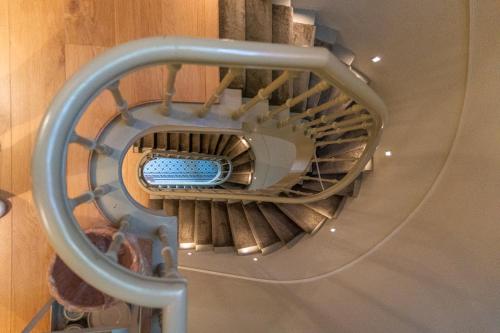 a spiral staircase in a building with a blue at Maison Brunon in Bruges