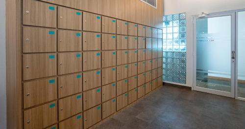 a wall of lockers in a room with a window at Bobopod Kota Tua, Jakarta in Jakarta