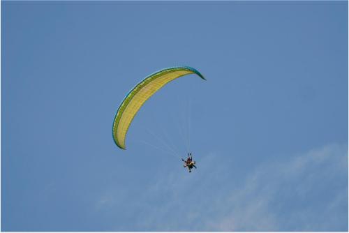 a person riding a paraglider in the sky at Yellow House in Pilipets