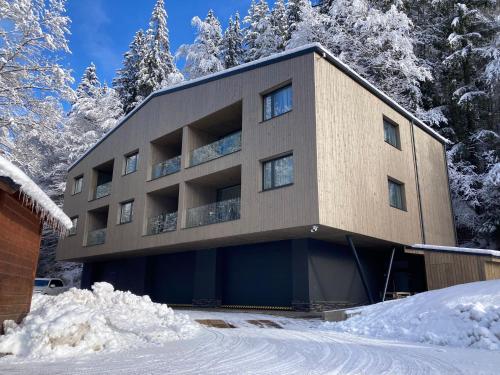 a building with snow in front of it at Apartmán Nicole in Tale