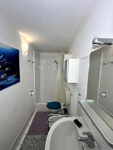 a white bathroom with a toilet and a sink at Suite Palazzo - Sanremo in Sanremo
