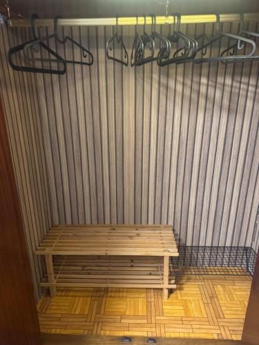 a wooden bench sitting in front of a curtain at RENFE-ALSA y clinicas in Oviedo