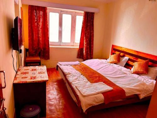 a bedroom with a large bed and a window at Hotel Ri ~ Rab Leh in Leh