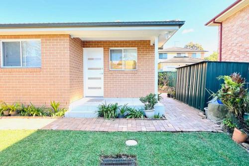 a brick house with a golf ball in the yard at Private & Cozy villa for you! in Sutherland